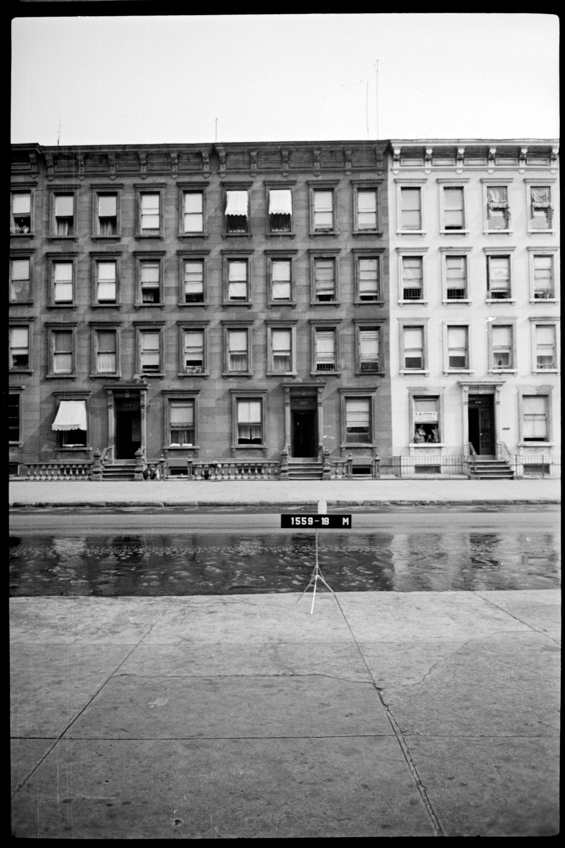 A row of four-story tenements on block 1559, West Sixty-Third Street between Amsterdam Avenue and West End Avenue, photographed by the New York City Department of Taxation around 1940. The Phipps Houses complex, where Thelonious Monk grew up, stood a few doors down on the same block.