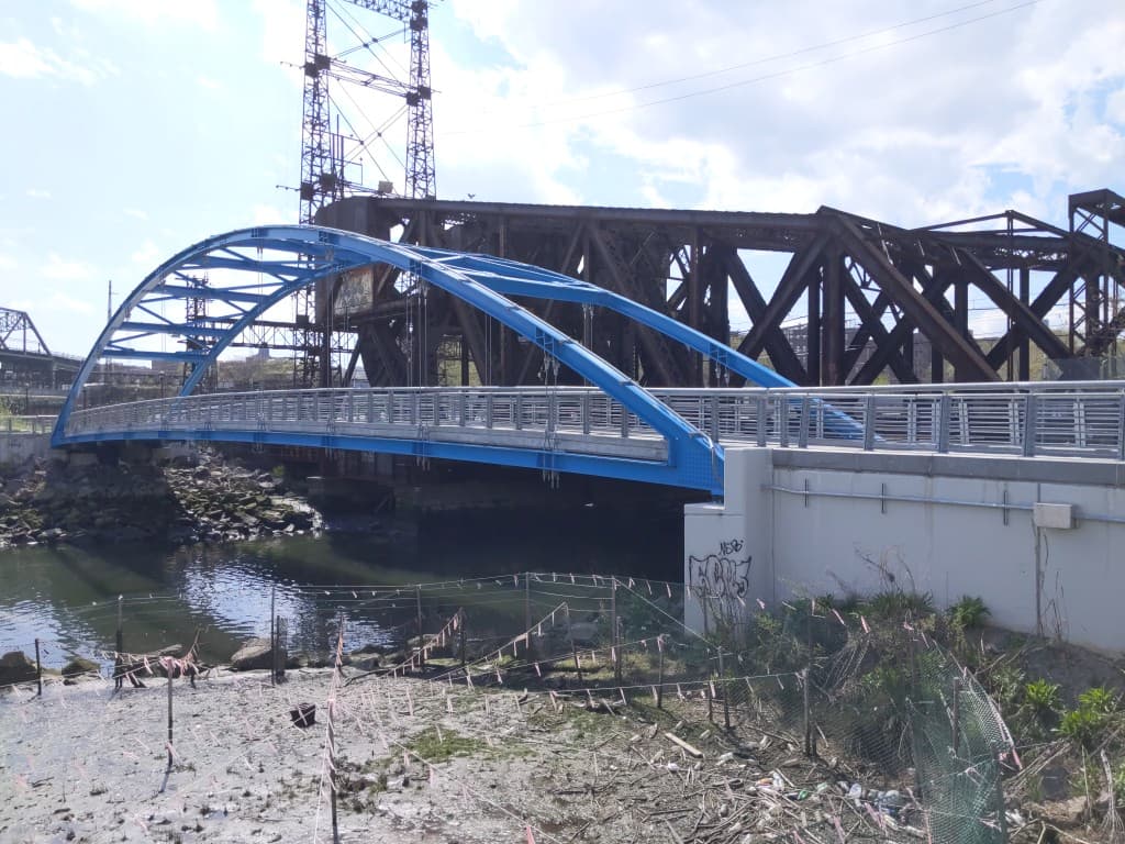 A pedestrian bridge over the Bronx River alongside a former bascule bridge, at Starlight Park in West Farms, part of the Bronx River Greenway the Bronx River Alliance and the New York City Parks Department reopened in 2013.